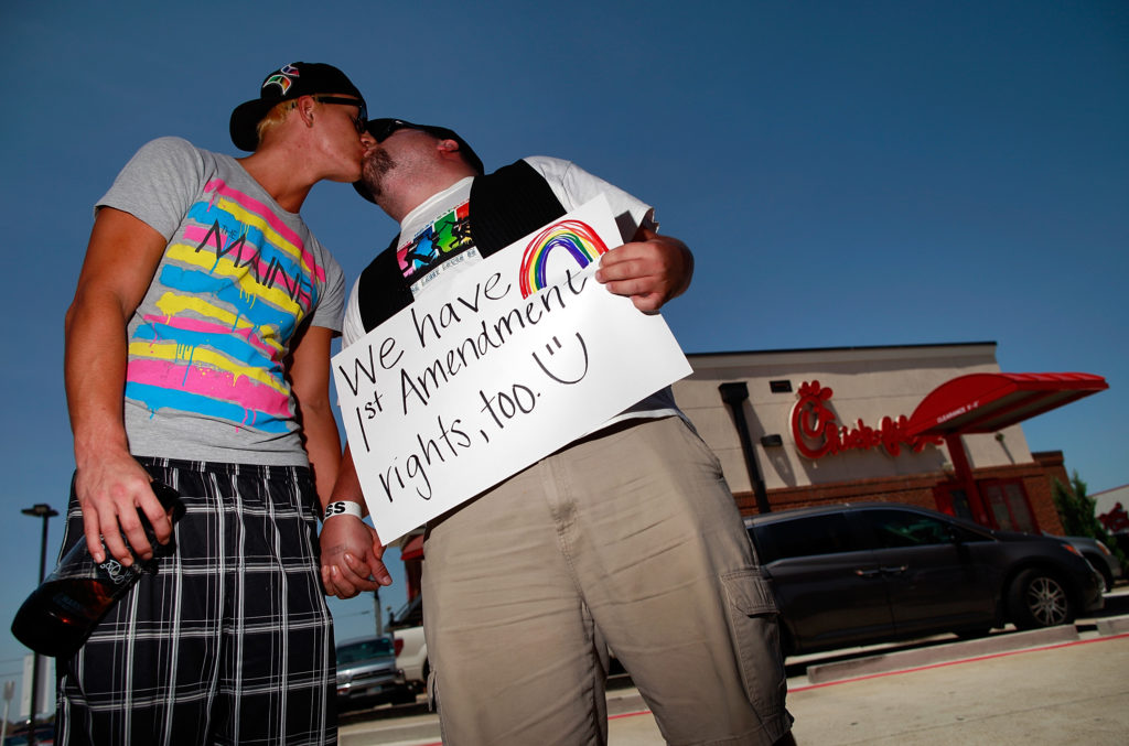 Same sex couple Tyler Savage and Larry Farris kiss outside a Chick-fil-A restaurant on August 3, 2012 in Dallas, Texas.