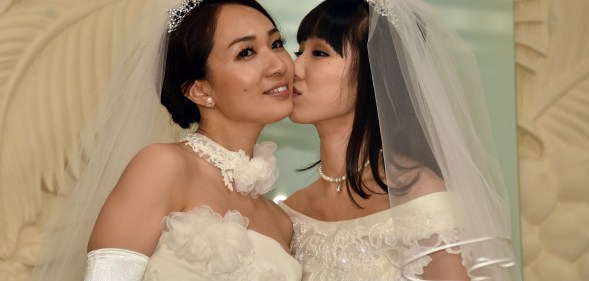 Japanese actress Akane Sugimori (R) kisses her partner Ayaka Ichinose in a 2015 protest for marriage equality, for which 13 gay couples are now suing the government on Valentine's Day.