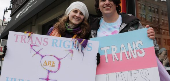 Transgender student Sorrel Rosin (R) poses with a friend February 25 2017 in Chicago as hundreds of transgender supporters protest against the Trump administration's reversal of federal protections of bathroom rights, warning it risked exposing young people to hate-fueled violence. Rosin, a high school student in Illinois, said Ive felt a spike in homophobia, transphobia, bigotry, misogyny in and out of school." / AFP / Derek R. HENKLE (Photo credit should read DEREK R. HENKLE/AFP/Getty Images)