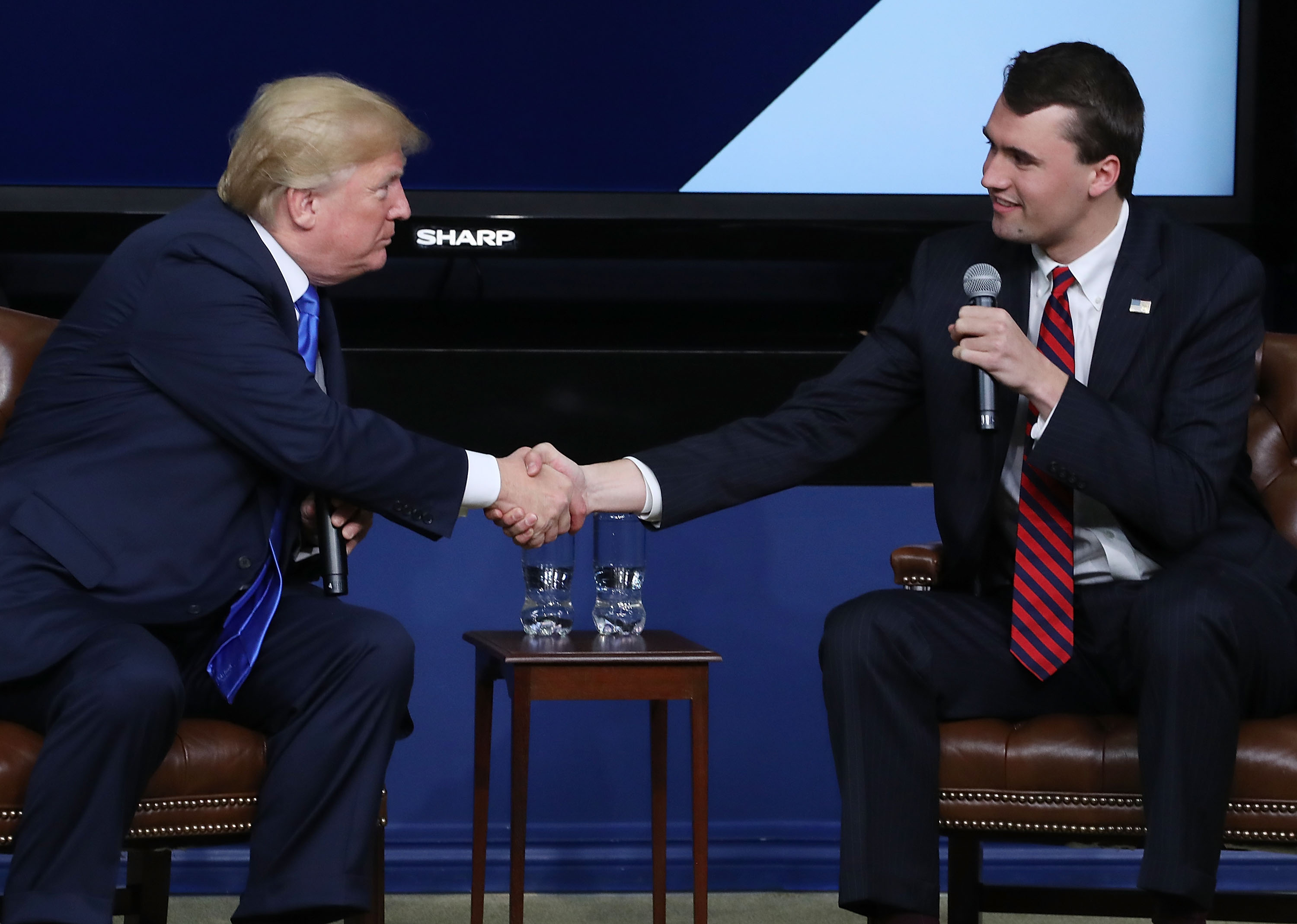 Image shows far right activist Charlie Kirk shaking hands with <a href=