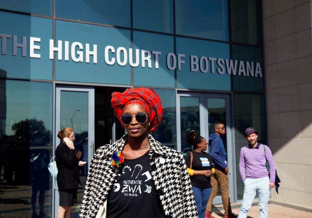 An activist poses for the camera outside Botswana High Court in Gaborone on June 11, 2019 after a ruling decriminalising homosexuality