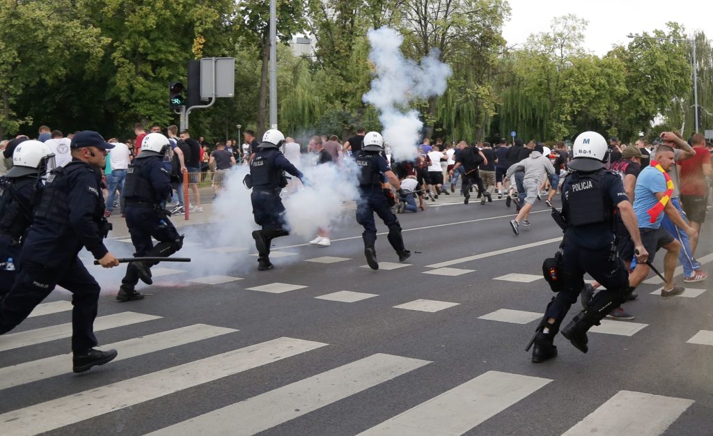 Riot police fire tear gas to disperse people, including ultra-nationalists, who attempted to block the pride march