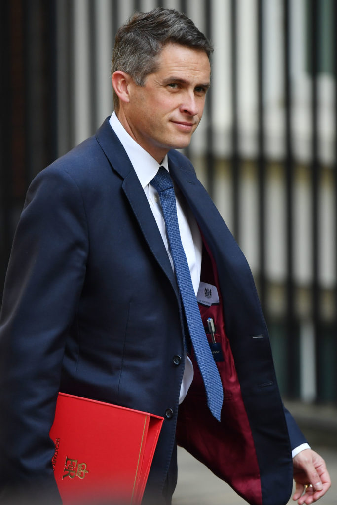 Gavin Williamson holding a red portfolio