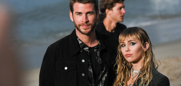 Liam Hemsworth and Miley Cyrus at Saint Laurent mens spring summer 20 show on June 06, 2019 in Malibu, California.