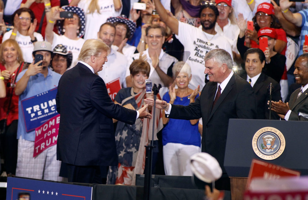 Franklin Graham with . President Donald Trump during a Trump rally on August 22, 2017 in Phoenix, Arizona.