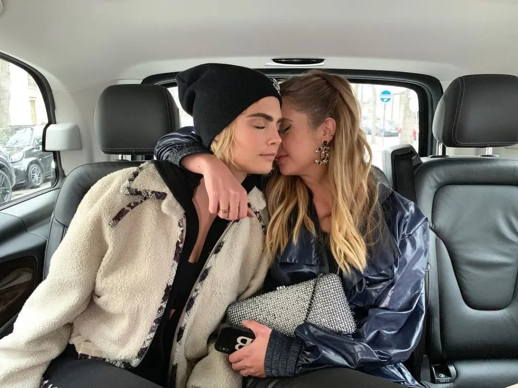 Ashley Benson wrapping an arm around Cara Delevingne in the back of a car