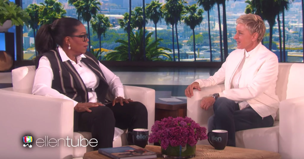 Oprah Winfrey and Ellen DeGeneres sitting opposite each other on armchairs