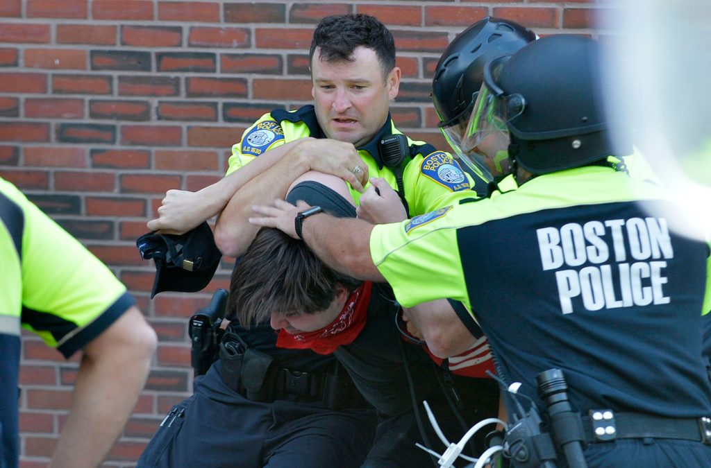 Boston Police officers arrest an anti-parade demonstrator during the "Straight Pride" parade in Boston, on August 31, 2019. 