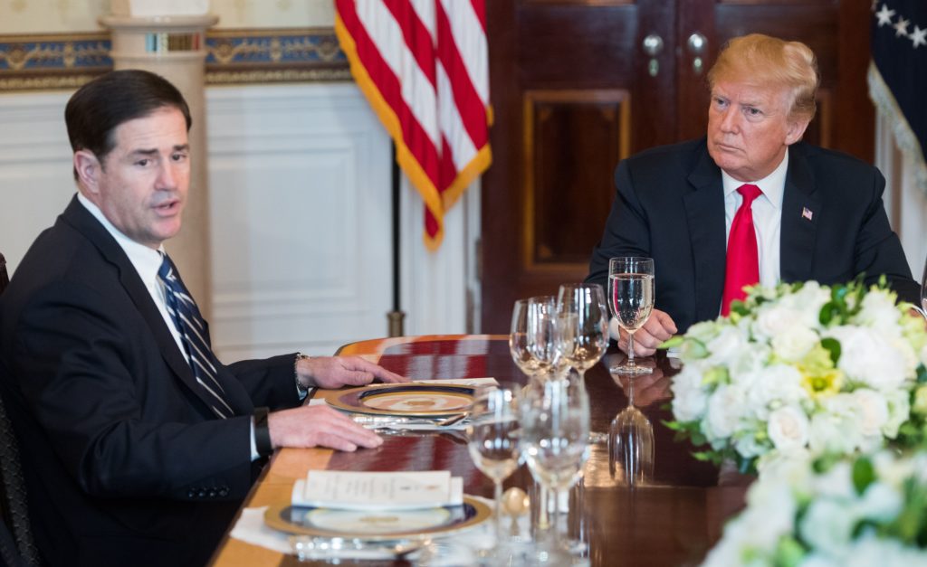 Arizona governor Doug Ducey speaks beside US President Donald Trump during a dinner with US state governors 