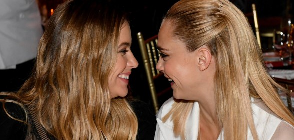 Ashley Benson and Cara Delevingne smiling at each other