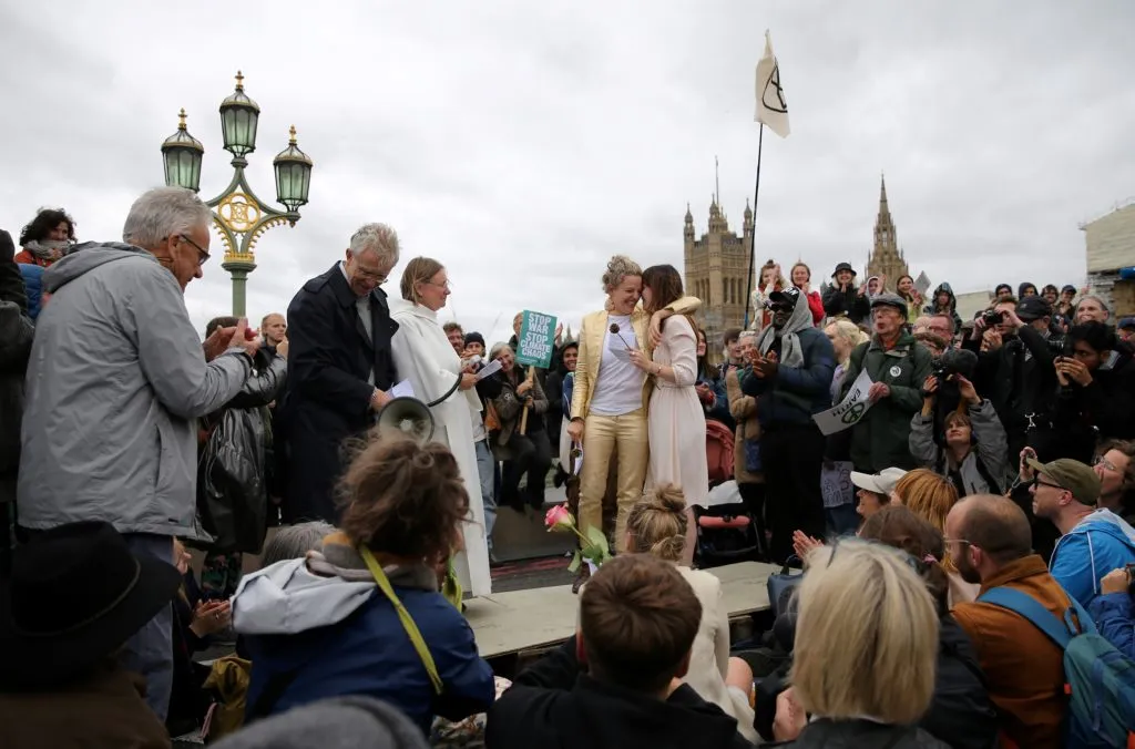 The pair were surrounded by activists from the climate change group Extinction Rebellion
