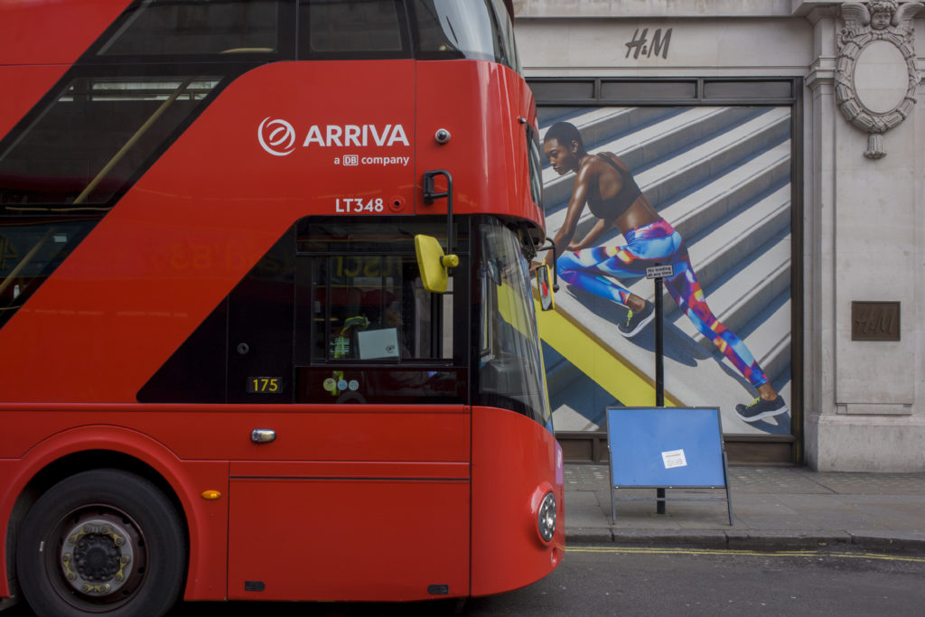 An Arriva bus pulls up in front of a H&M store in London. (In Pictures Ltd./Corbis via Getty Images)