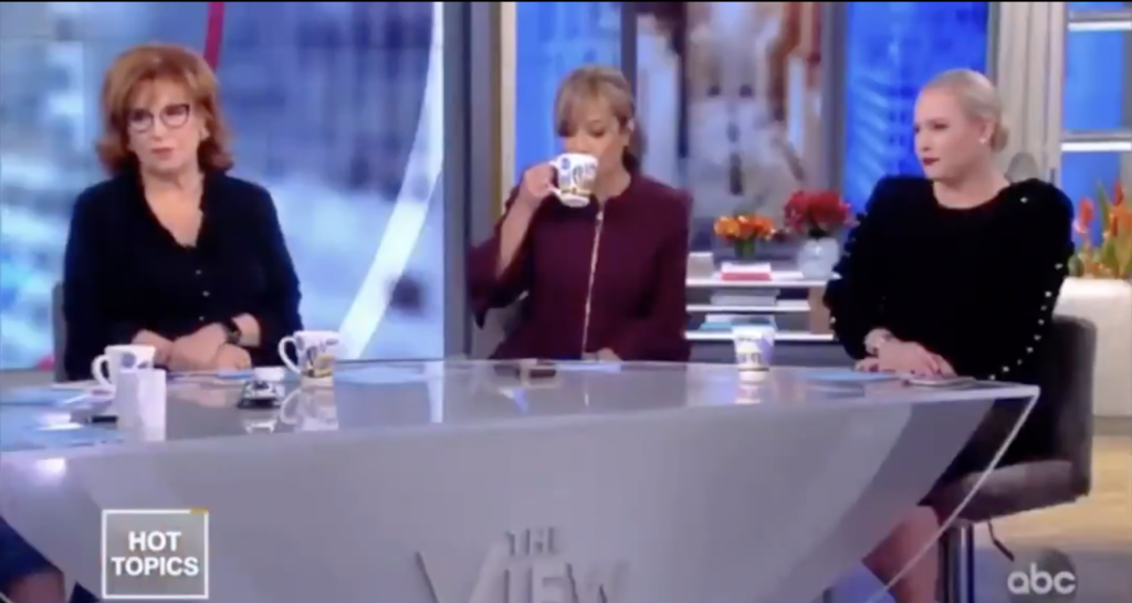 Columnist Sunny Hostin (C) was every viewer as she cooly sipped her tea during the fiery exchange unfolding in front of her. (Screen capture via Twitter)