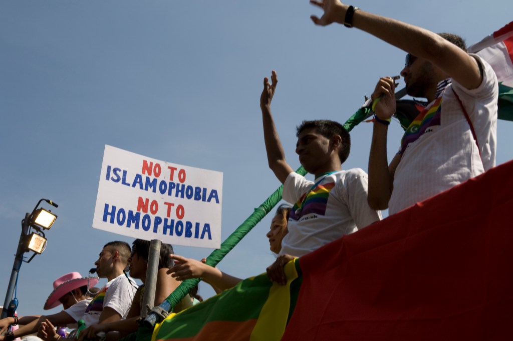 Members of Imaan wave from atop a float during the EuroPride parade.