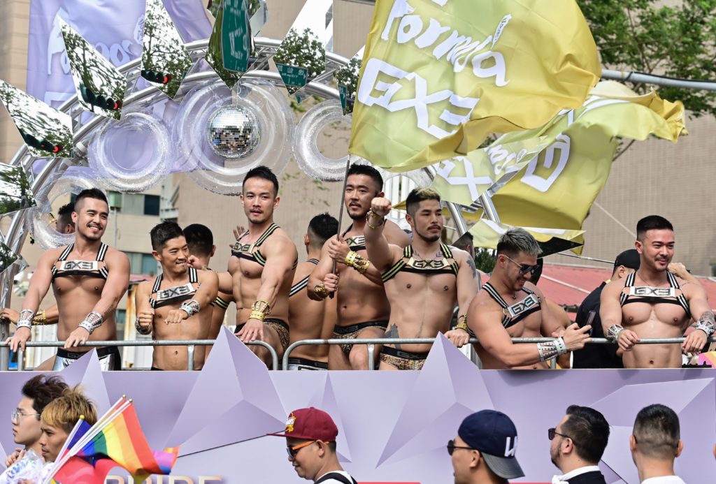 Topless men wearing briefs and harnesses on a float during Taiwan Pride 2019
