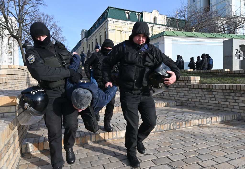 Policemen detain an individual who was protesting against the Transgender Day of Remembrance event in Kyiv. (Genya SAVILOV / AFP) (Photo by GENYA SAVILOV/AFP via Getty Images)