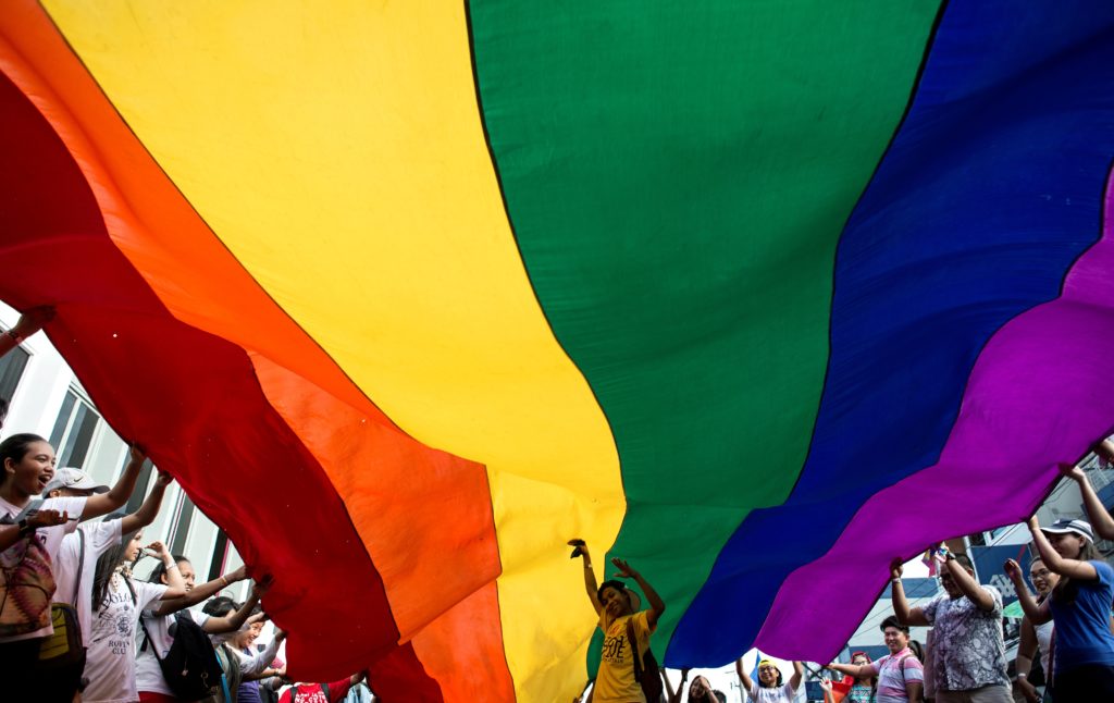 Participants parade a LGBT+ flag during a Pride pride march in Manila. (NOEL CELIS/AFP via Getty Images)