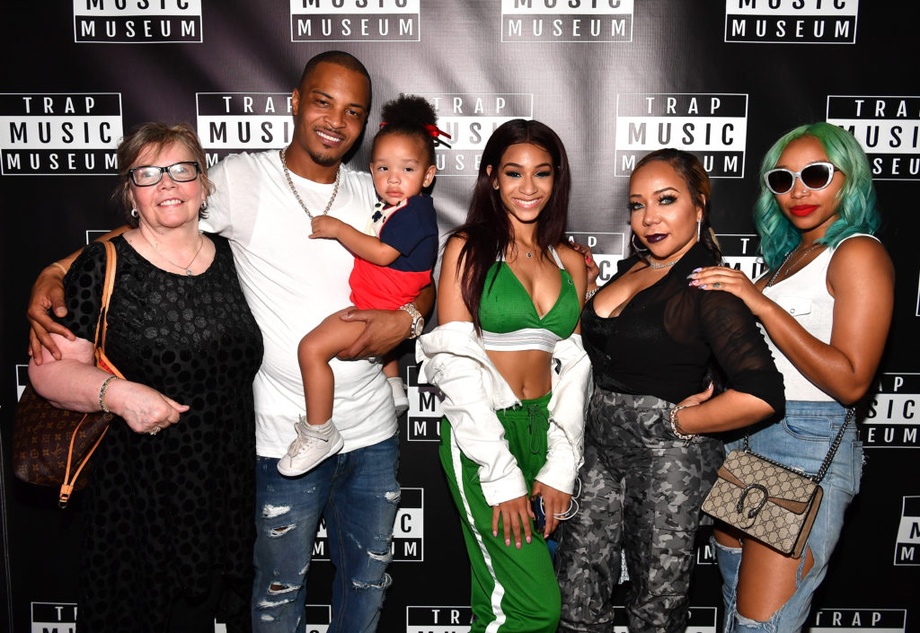T.I. pictured with his daughter Deyjah (centre) and family.