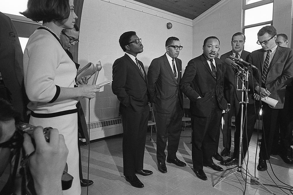 American Civil Rights leader Dr. Martin Luther King Jr speaks to journalists at a 1968 press conference, with Bayard Rustin center left