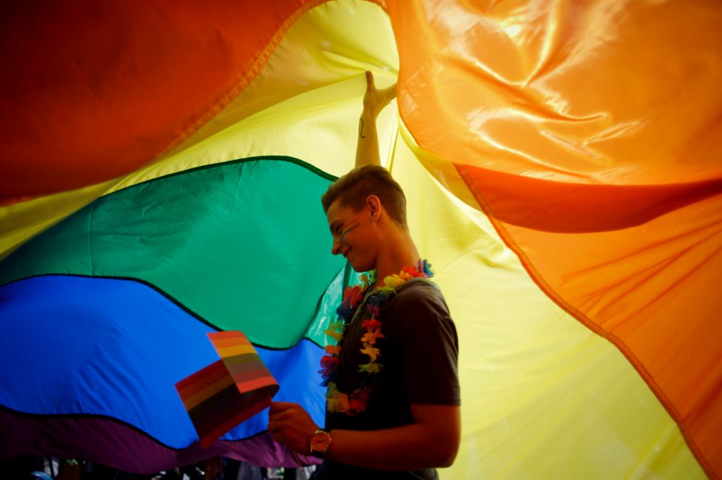 Participant dances as he holds up a large rainbow flag during the third Prague Pride March on August 17, 2013 in Prague, Czech Republic. (Matej Divizna/Getty Images)