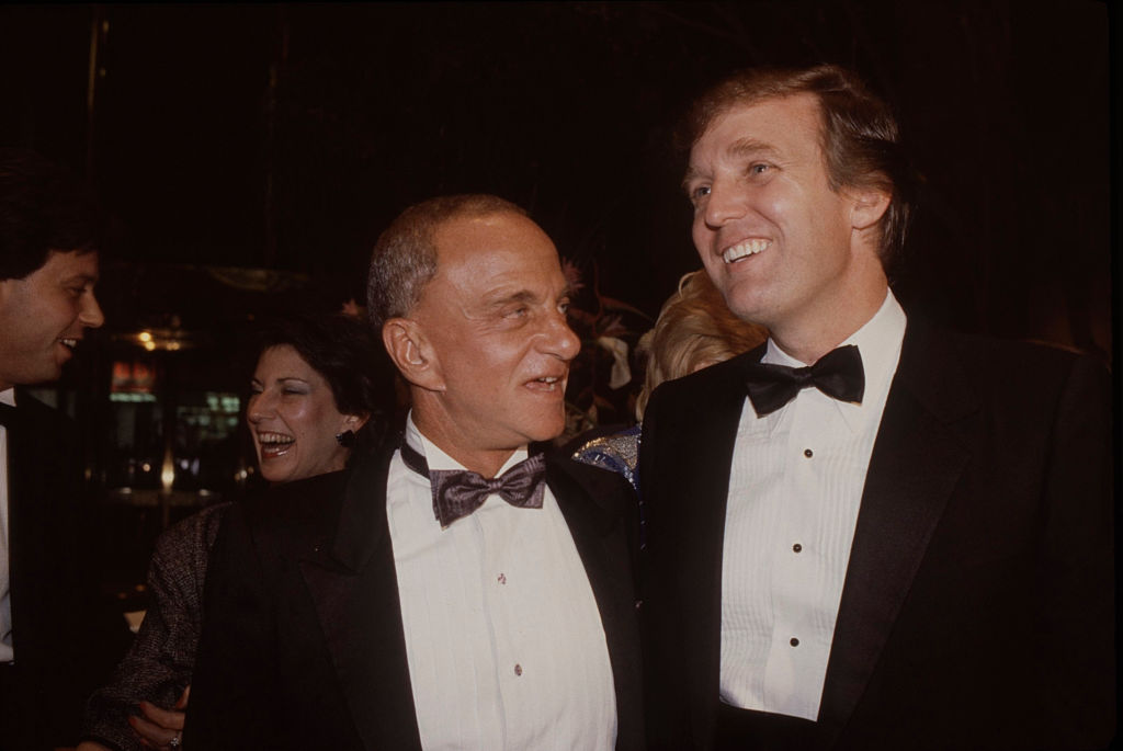 Roy Cohn, who died from HIV/AIDS, and Donald Trump attend the Trump Tower opening in October 1983