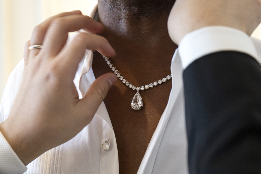 Close-up of Billy Porter wearing a diamond drop necklace from Tiffany & Co