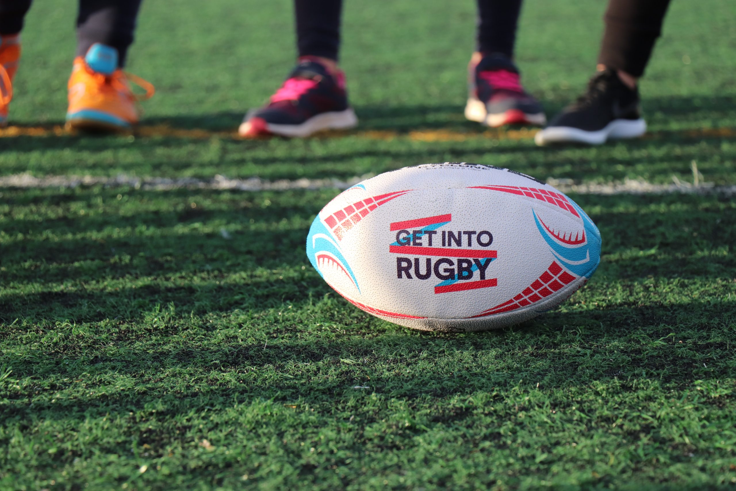 A rugby ball on a pitch