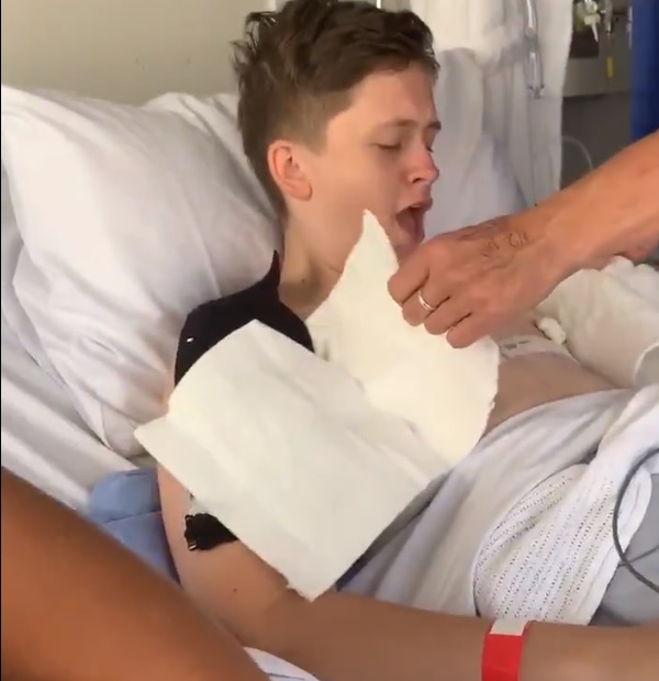 The powerful clip shows bandages being carefully removed in hospital after top surgery.