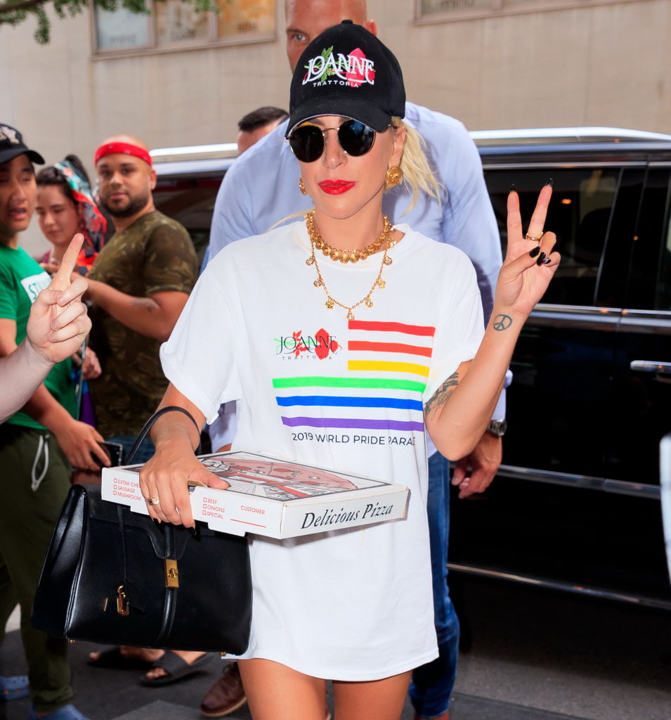 Lady Gaga wears a Joanne Trattoria Pride shirt while carrying a pizza box on June 28, 2019 in New York City. 