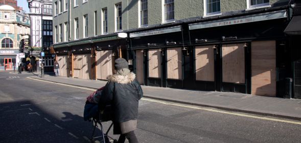 Bars and restaurants boarded up and closed down on Old Compton Street in Soho, at the heart of the West End