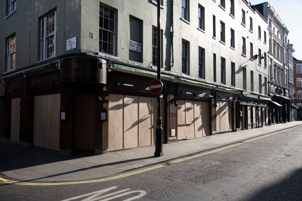 Bars and restaurants boarded up and closed down on Old Compton Street in Soho, at the heart of the West End 