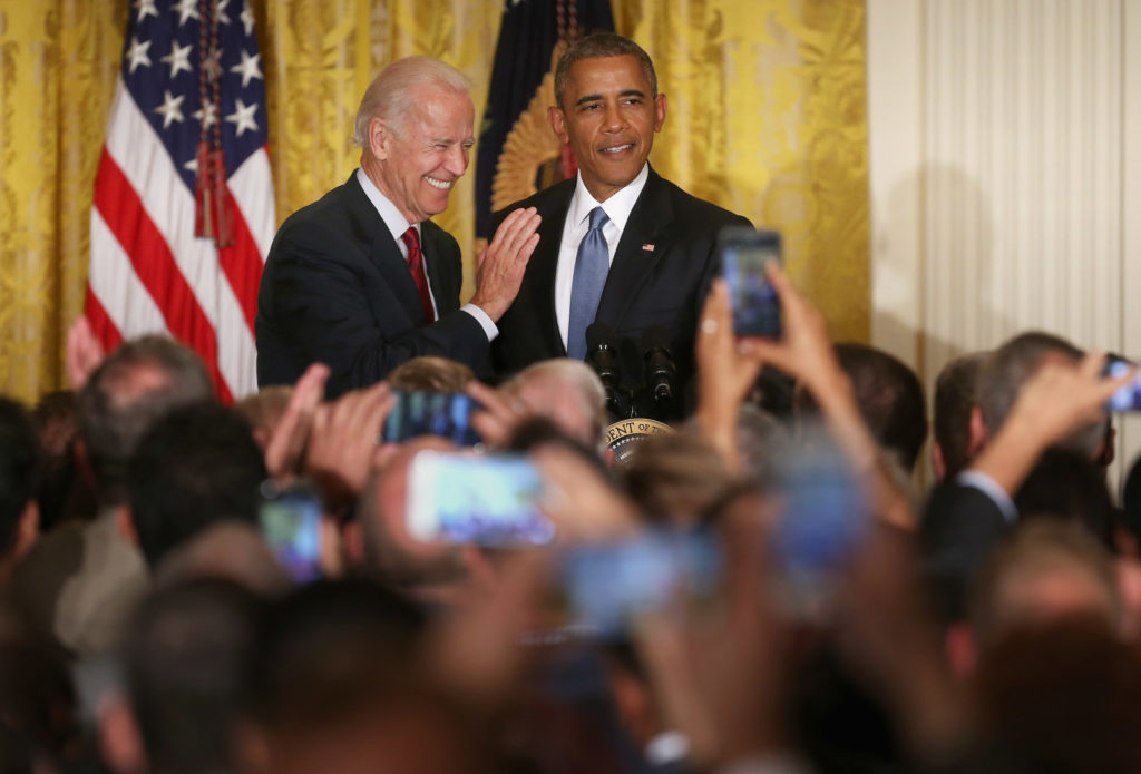Former US president Barack Obama (R) and vice president Joe Biden react after a heckler is removed from a reception for LGBT Pride Month in the East Room of the White House. (Chip Somodevilla/Getty Images)