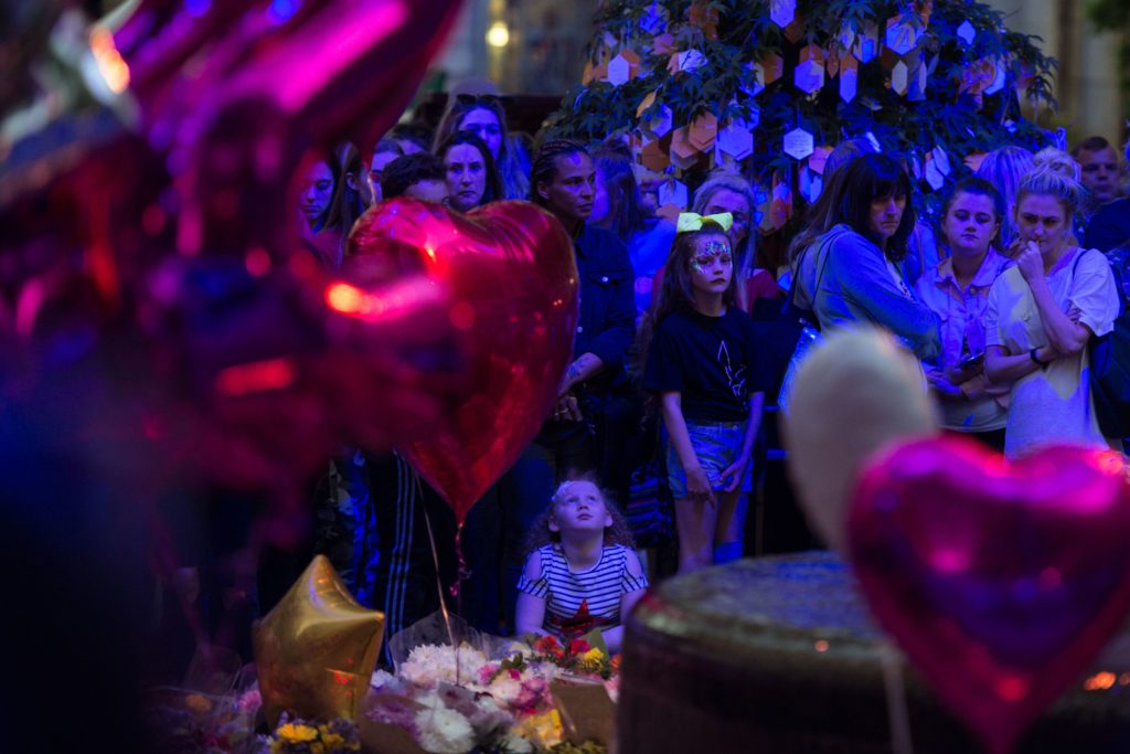 People pay their respects during a ceremony in central Manchester. (OLI SCARFF/AFP via Getty Images)