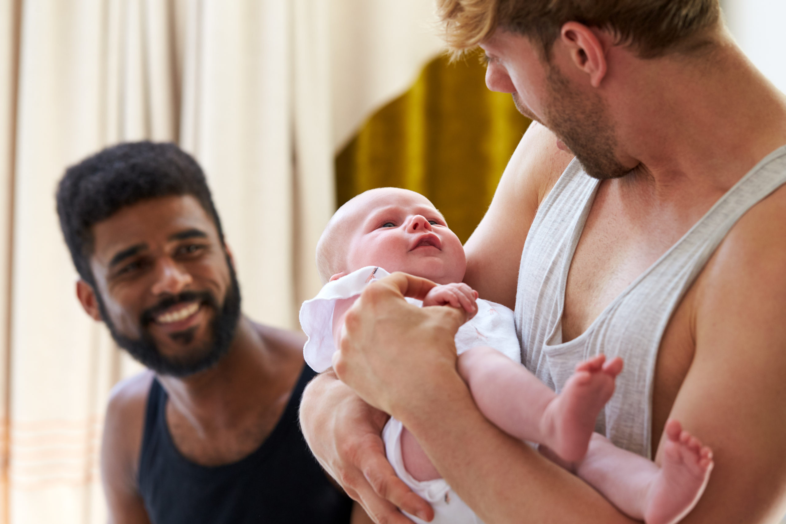 Gay couples in surrogacy battle unable to return home with their babies