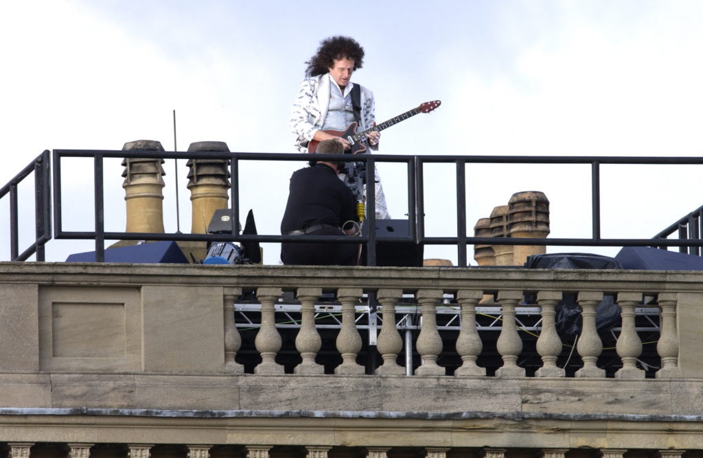 Brian May performing on the roof of Buckingham Palace in 2012. (Tim Graham Photo Library via Getty Images)