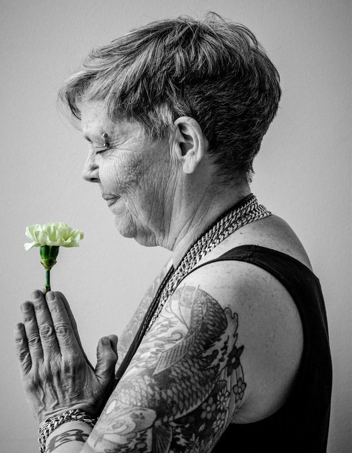 Jamie Wildman holds a flower in the play poster