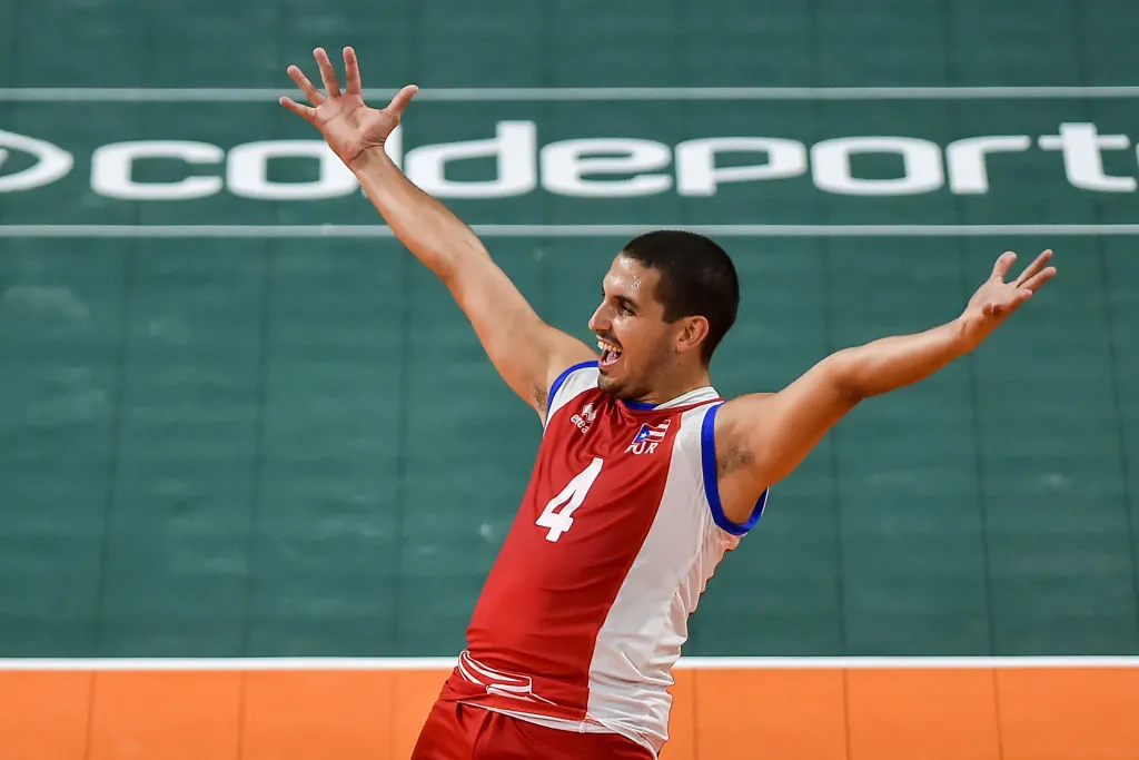 Dennis Del Valle of Puerto Rico celebrates after scoring a point against Colombia in the men's volleyball match for the gold medal during the 2018 Central American and Caribbean Games 