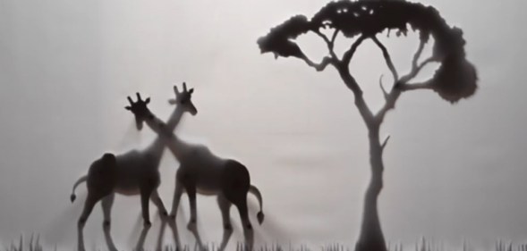 Shadow puppets of two gay giraffes rubbing necks