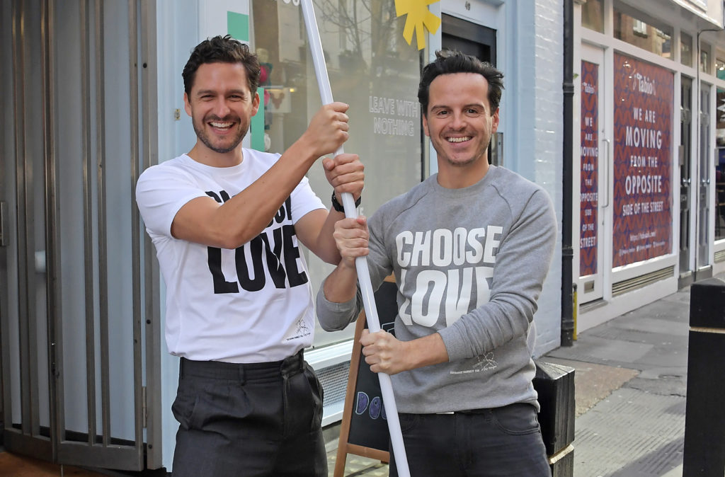 Ben Aldridge (L) and Andrew Scott volunteer during Match Fund day at the 'Choose Love' shop for Help Refugees in London. (David M. Benett/Dave Benett/Getty Images)