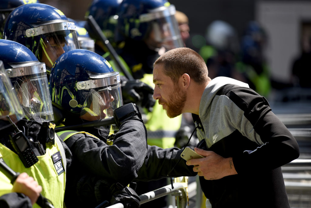 A argues squares off with a police officer on Parliament Street on June 13, 2020 in London. (Kate Green/Anadolu Agency via Getty Images)