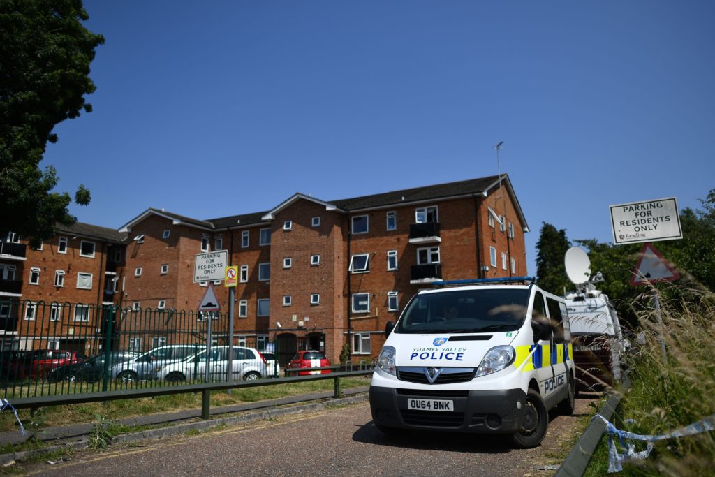 A police van is parked outside a cordoned off block of flats where the suspect of a multiple stabbing incident lived in Reading. (BEN STANSALL/AFP via Getty Images)