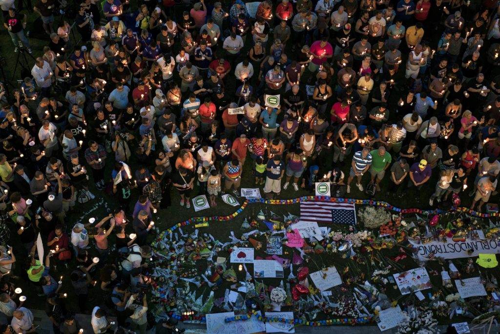 Mourners hold candles while observing a moment of silence during a vigil outside the Dr. Phillips Center for the Performing Arts for the mass shooting victims at the Pulse nightclub June 13, 2016. (BRENDAN SMIALOWSKI/AFP via Getty Images)