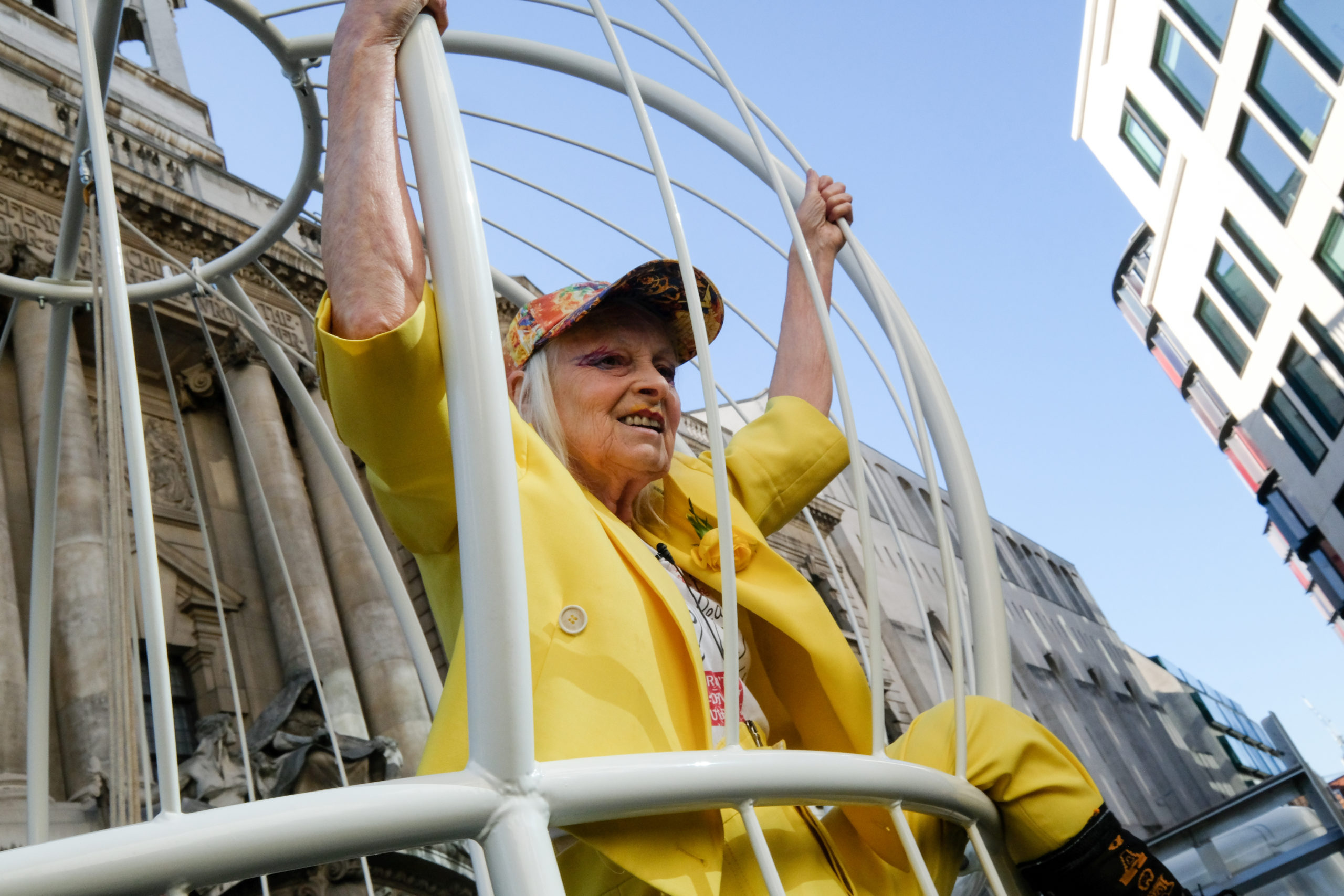 Vivienne Westwood swings inside giant birdcage to support Julian