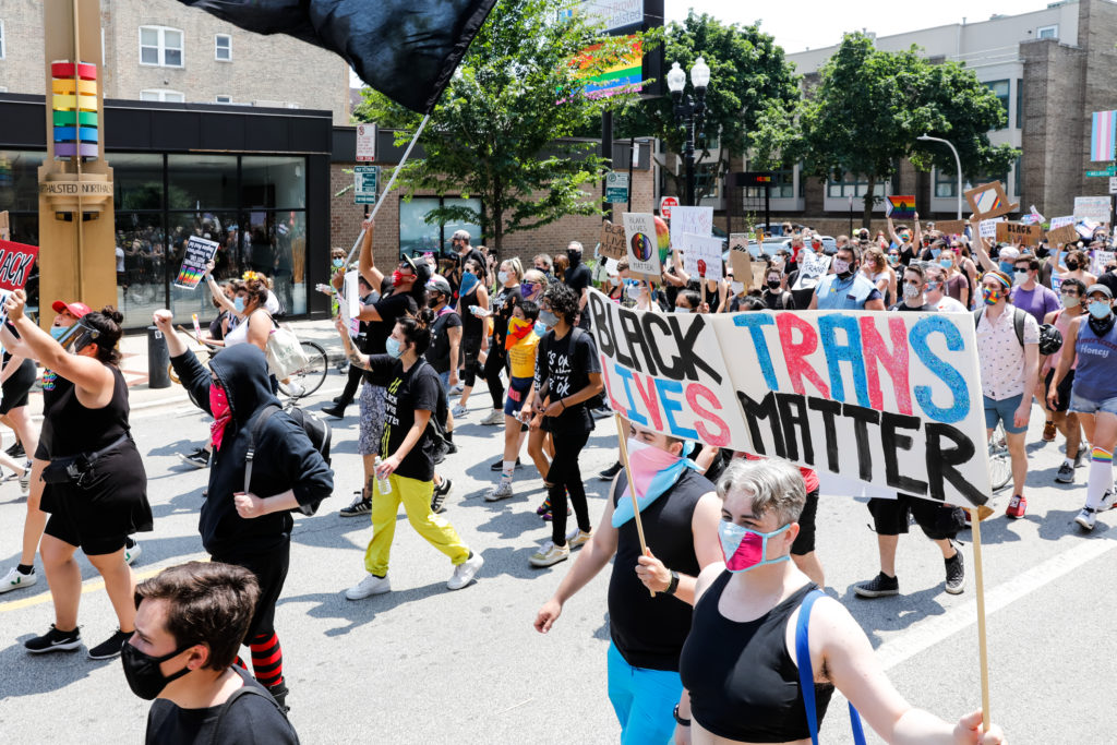 Protesters hold signs during the Pride Without Prejudice march in Boystown on June 28, 2020 in Chicago, Illinois. (Natasha Moustache/Getty Images)