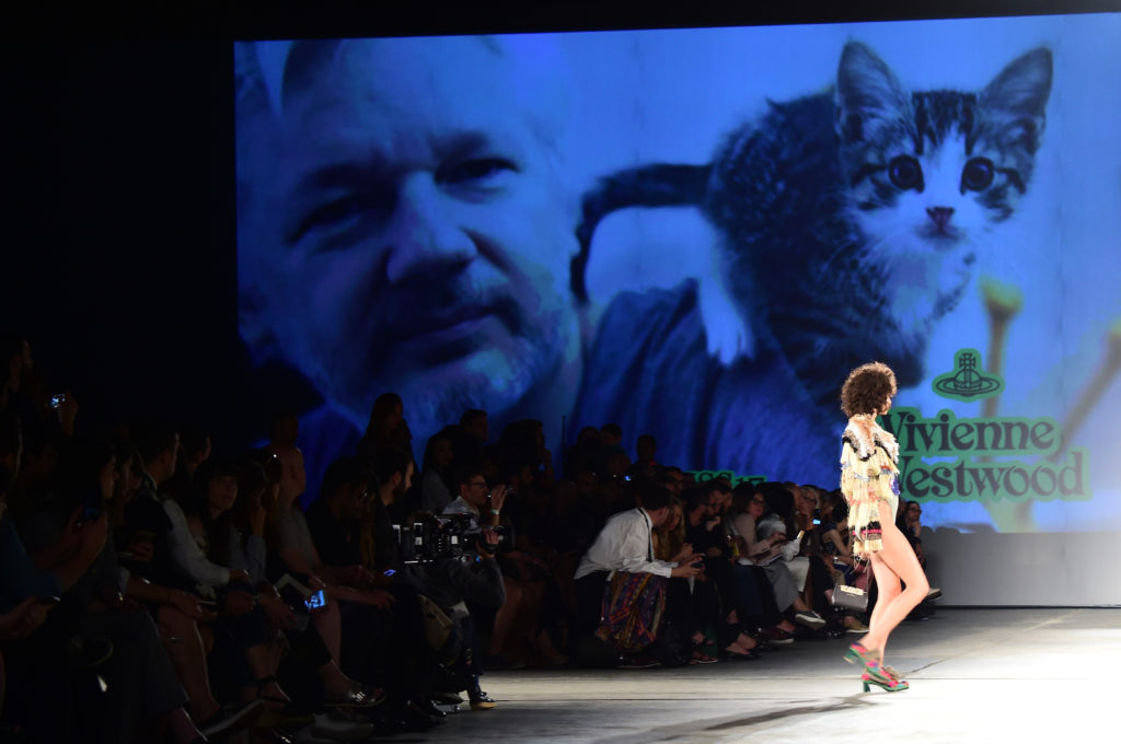 A picture of WikiLeaks founder Julian Assange is seen on a giant screen at the show for fashion house Vivienne Westwood during the Men's Spring/Summer 2017 fashion show. (GIUSEPPE CACACE/AFP via Getty Images)