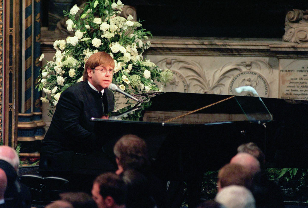 Elton John sings 'Candle in the Wind' at the funeral of Diana, Princess of Wales. (Anwar Hussein/Getty Images)