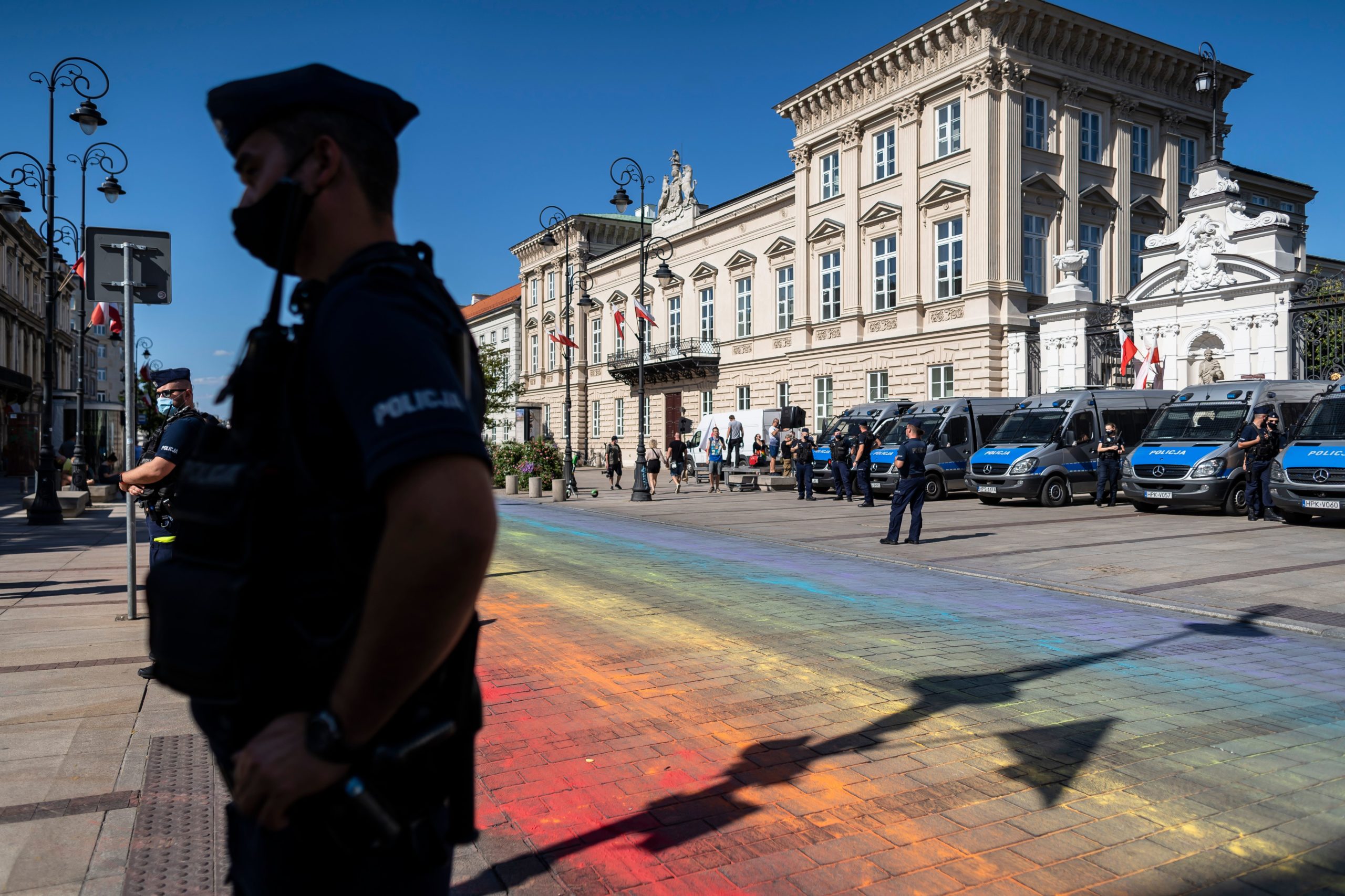 Police stand guard after the street is painted in rainbow colours 