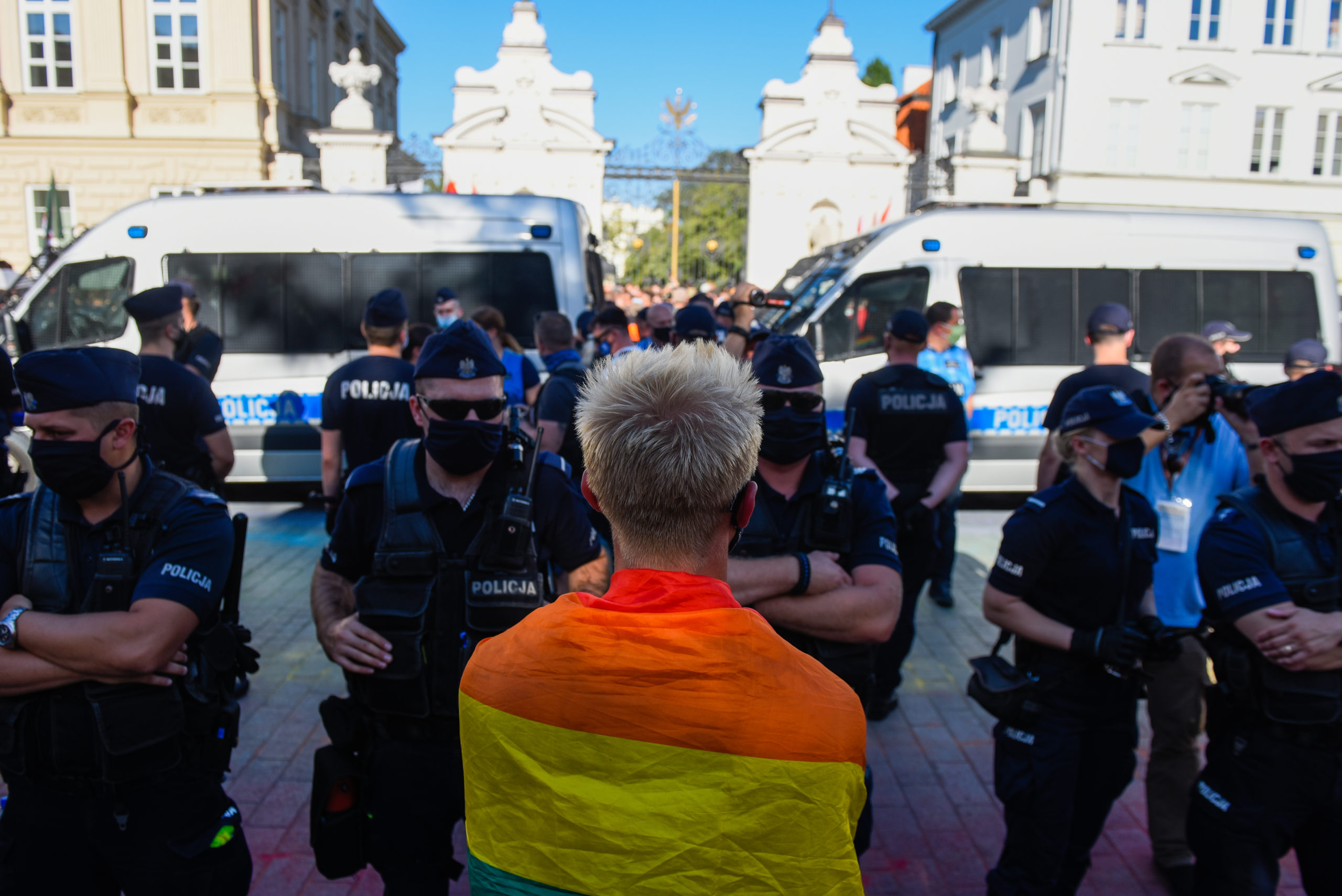 An LGBT activist wears a rainbow flag during a counter protest against an anti-LGBT far right rally on August 16, 2020 in Warsaw, Poland. 