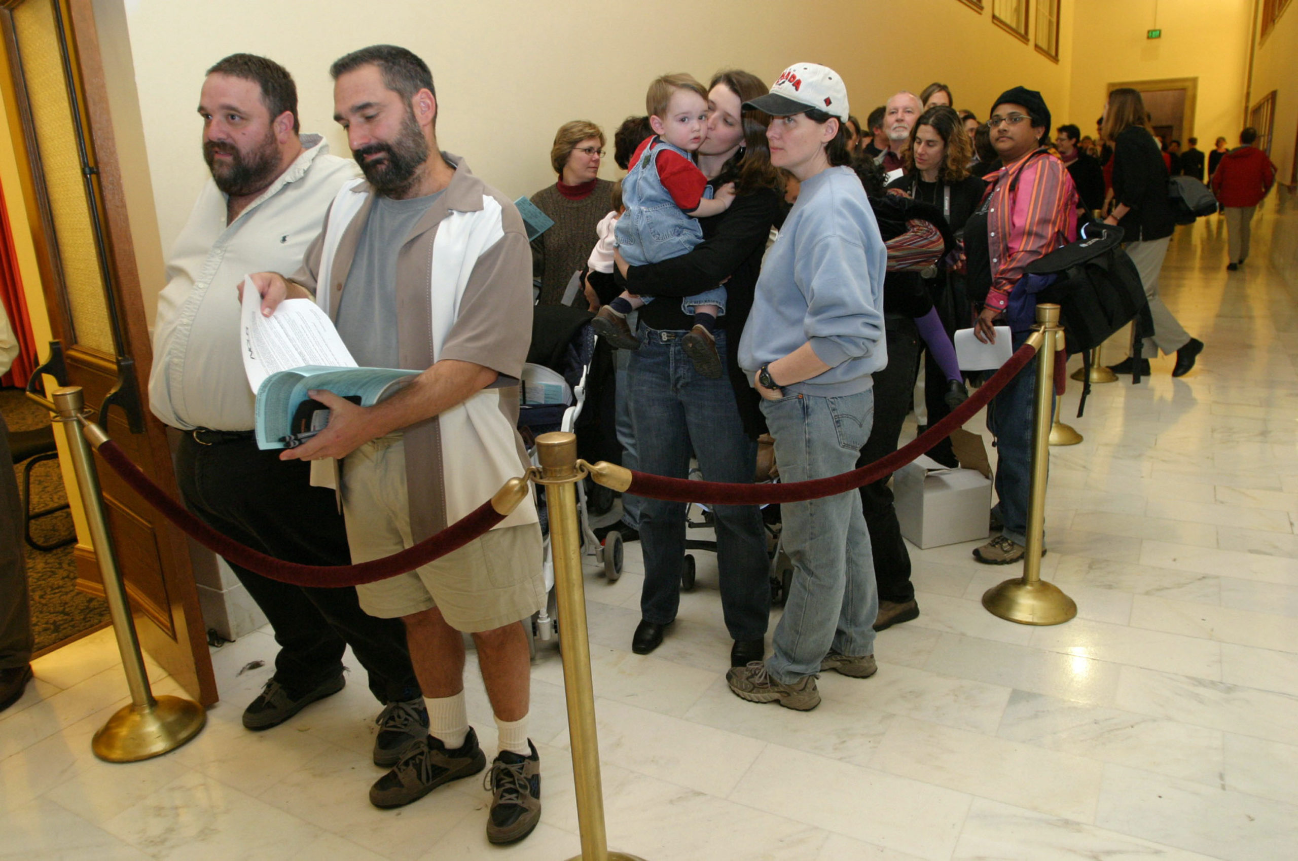Hundreds of gay couples line up in front of the County Clerk's office at San Francisco City Hall to register for marriage forms on February 13, 2004