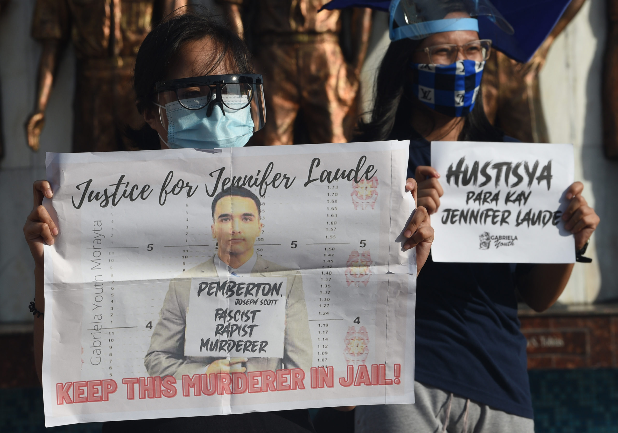 Demonstrators in Manila display placards to protest against Philippine President Rodrigo Duterte's decision to pardon US marine Lance corporal Joseph Scott Pemberton who was convicted of killing Jennifer Laude